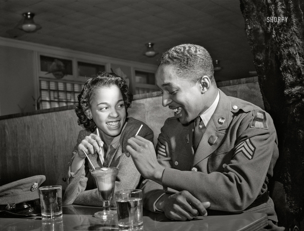 Photo showing: At Ease, Soldier -- March 1942. Baltimore, Maryland. Sergeant Franklin Williams, home on
leave from Army duty, with his best girl Ellen Hardin, splitting a soda.