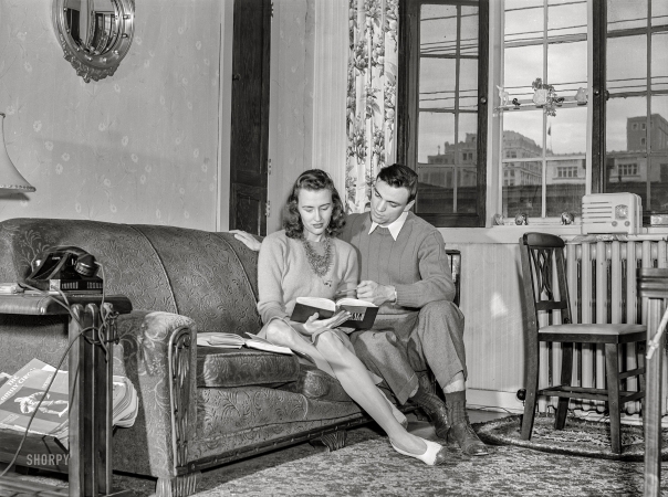 Photo showing: Coeducation -- May 1942. University of Nebraska during final exam
week. Bob Aden studying with his wife in their apartment.