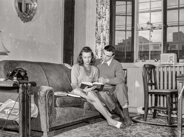 Photo showing: Coeducation -- May 1942. University of Nebraska during final exam
week. Bob Aden studying with his wife in their apartment.