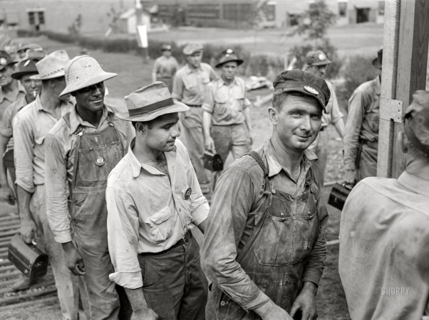 Photo showing: Chemical Brothers -- June 1942. Wilson Dam, Alabama. Tennessee Valley Authority.
Workers checking out at end of shift at a chemical engineering plant.