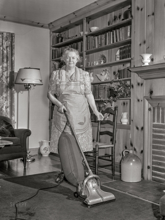 Photo showing: Dirt Farmer -- June 1942. Knox County, Tennessee. Electrification of farms
made possible by TVA. Mrs. Wiegel uses electric vacuum cleaner.
