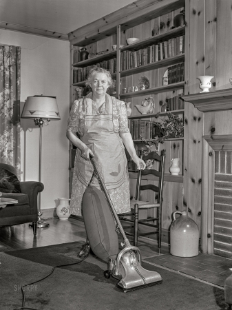 Photo showing: Dirt Farmer -- June 1942. Knox County, Tennessee. Electrification of farms
made possible by TVA. Mrs. Wiegel uses electric vacuum cleaner.