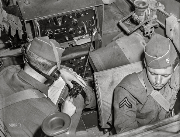 Photo showing: Signal Corps -- April 1942. Fort Riley, Kansas. Signal Corps unit communicating by radio from a scout car.