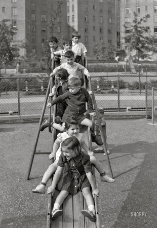 Photo showing: Queenslide -- June 1942. Queens, New York.  Nursery school at the Queensbridge housing project. Children on a slide.