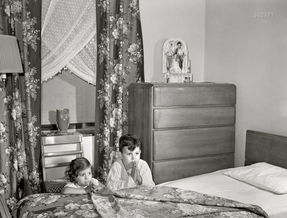 Photo showing: Bless Leo Durocher -- June 1942. Brooklyn, New York. Red Hook housing development.
Jimmy Caputo, 7 years old, and Annette, 4, at their nightly prayers.