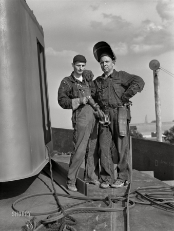 Photo showing: Joined at the Ship -- July 1942. Decatur, Alabama. Ingalls Shipbuilding Company. A shipfitter and his helper.