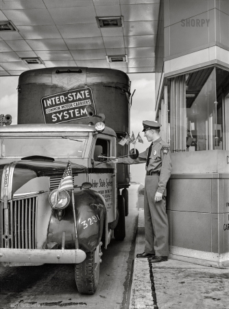 Photo showing: Turnpike Trucker -- July 1942. Pennsylvania Turnpike. Trucker paying toll.