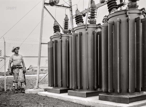Photo showing: Transformers -- July 1942. Hayti, Missouri. U.S. Rural Electrification
Administration lineman examining transformers of a substation.