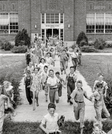 Photo showing: Schools Out! -- July 1942. Dunklin County, Missouri. Children leaving school.