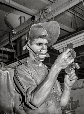 Photo showing: Size Matters -- September 1942. Detroit, Michigan. Learner at the Allison Motors plant. Dimensional finishing.