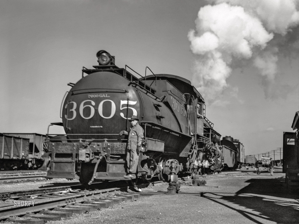Photo showing: Yardwork -- November 1942. Chicago, Illinois. Tender and switch engine at an Illinois Central railyard.