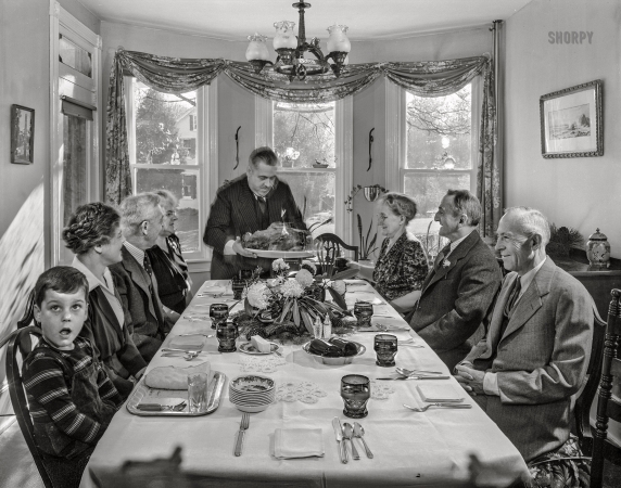 Photo showing: Brown Thursday -- November 1942. Neffsville, Pennsylvania. Serving the turkey at Thanksgiving dinner in the home of Earle Landis.