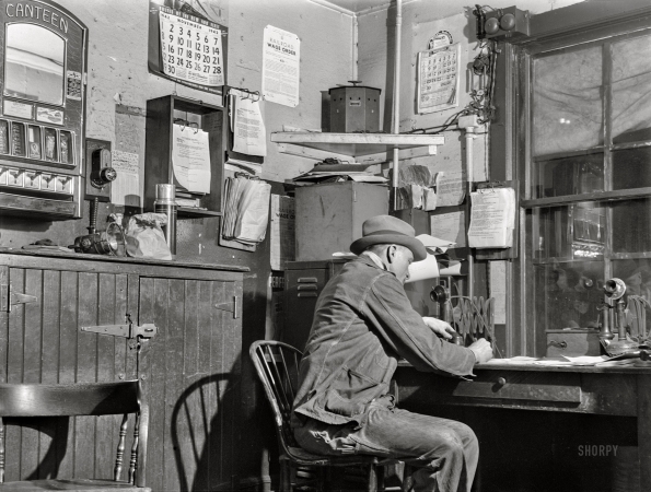 Photo showing: Hump Office -- December 1942. Train clerk working on his lists in the hump office at a Chicago and North Western railyard.