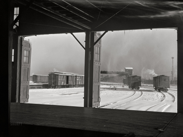 Photo showing: Frosty Freight -- December 1942. Chicago, Illinois. Looking out toward the icehouse
from the freighthouse at a yard of the Chicago and North Western Railroad.