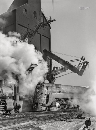 Photo showing: Feeding Station -- December 1942. Chicago, Illinois. Chicago & North Western locomotive at the coaling station.