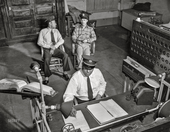 Photo showing: The Alarm Desk -- January 1943. Washington, D.C. Firehouse Station No. 4. Lieutenant Mills on duty at the alarm desk.