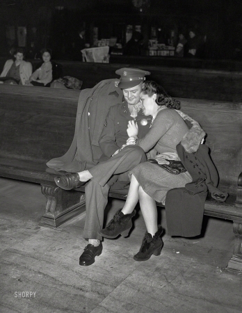 Photo showing: Basic Training. -- February 1943. Soldier and his girl waiting for a train at Chicago Union Station.