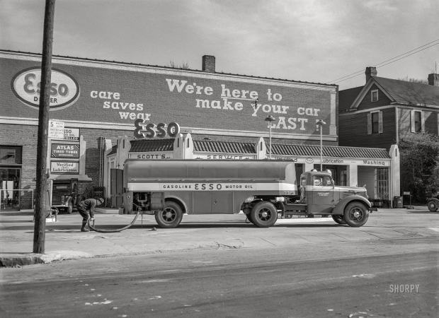 Photo showing: Verified Lubrication -- March 1943. Charlotte, North Carolina. Gasoline truck making a delivery at a filling station.
