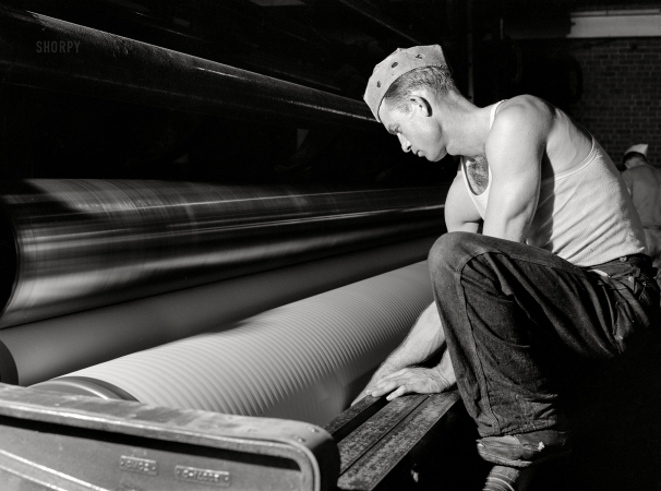 Photo showing: Paper Work -- April 1943. Lufkin, Texas. Southland Paper Mills worker with equipment used to produce 18-foot rolls of newsprint.