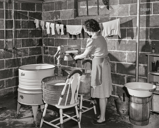 Photo showing: Laundry Dungeon -- May 1943. Point Pleasant, West Virginia. Mayme Ferguson wringing out clothes.