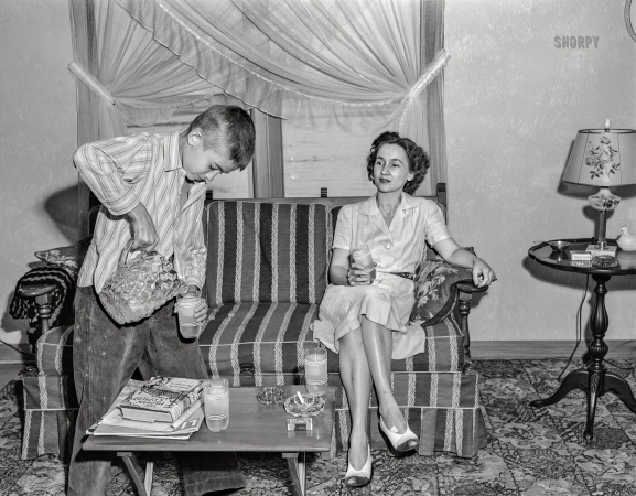 Photo showing: The Human Comedy -- May 1943. Point Pleasant, West Virginia. Jimmie Ferguson pouring out a glass of lemonade.
