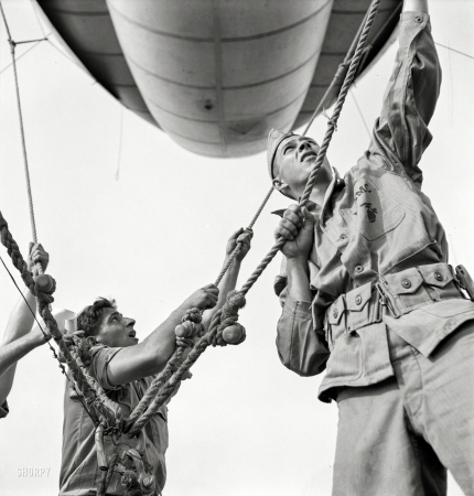 Photo showing: Balloon Jockeys -- May 1942. Parris Island, South Carolina. U.S. Marine Corps glider detachment training camp.
A barrage balloon takes to the air under capable handling by a Marine Corps ground crew.