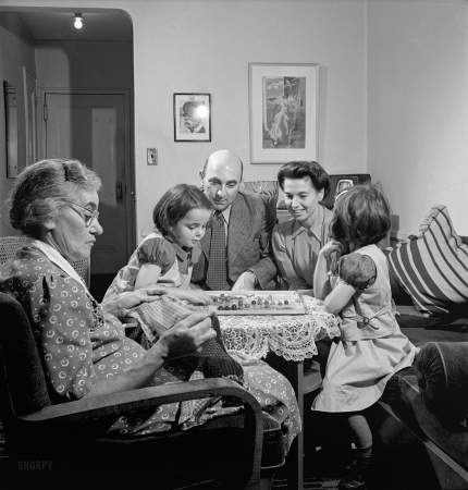 Photo showing: Chinese Czechers -- October 1942. New York, New York. Dr. and Mrs. Winn [or Wynn], Janet and Marie,
a Czech-American family, playing Chinese checkers while Grandmother knits.
