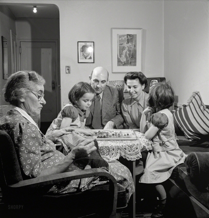 Photo showing: Chinese Czechers -- October 1942. New York, New York. Dr. and Mrs. Winn [or Wynn], Janet and Marie,
a Czech-American family, playing Chinese checkers while Grandmother knits.
