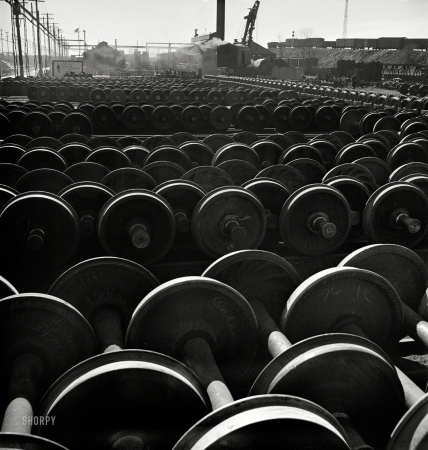 Photo showing: Field of Wheels -- November 1942. Wheels and axles outside the locomotive shops at an Illinois Central Railroad yard.