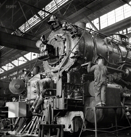Photo showing: Tune-Up Time -- December 1942. Chicago, Illinois. Locomotive under repair at the Chicago & North Western shops.