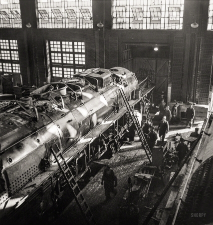 Photo showing: Fire-Eater -- December 1942. Working on a giant locomotive, one of the '400s,' in the Chicago & North Western Railroad shops.