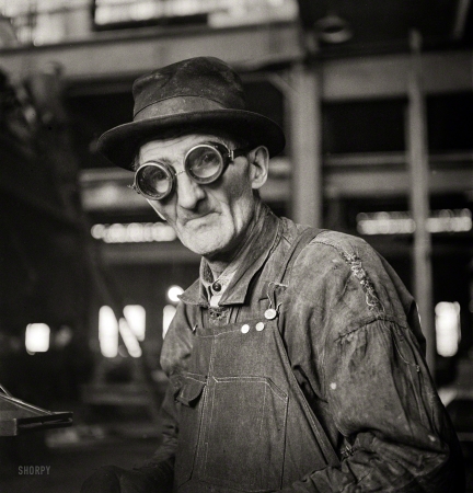 Photo showing: Goggle Glass -- December 1942. Chicago, Illinois. Workman grinding out
a part at the Chicago & North Western repair shops.