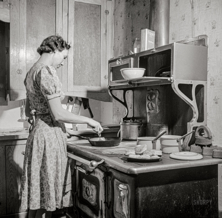 Photo showing: Skillet Supper -- February 1943. Moreno Valley, Colfax County, New Mexico. William Heck's wife getting supper.