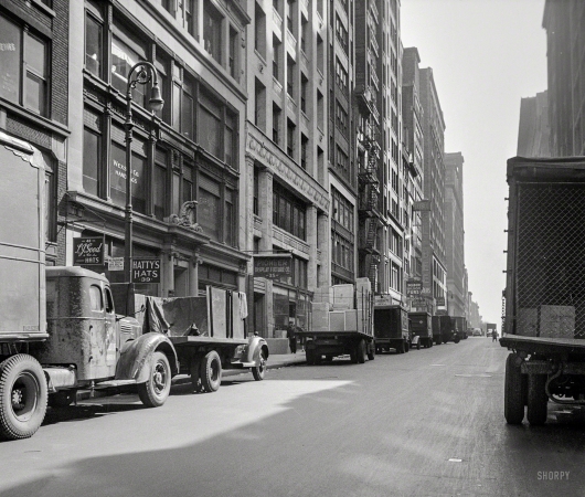 Photo showing: Hattys Hats -- March 1943. New York, New York. Trucks in the garment district.