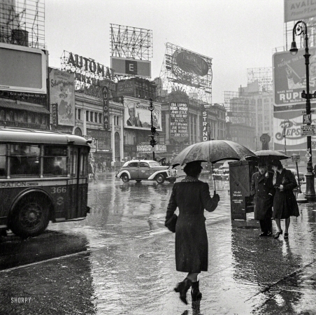 Photo showing: Rainy Day People -- March 1943. New York, New York. Times Square on a rainy day.