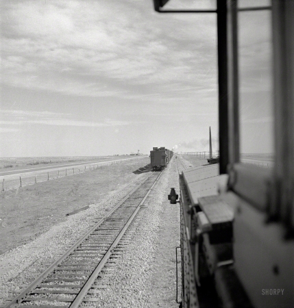 Photo showing: Eastbound Freight -- March 1943. Parmerton, Texas. Passing an eastbound freight on the Santa Fe between Amarillo and Clovis, New Mexico. 