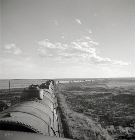 Photo showing: Far Horizons -- March 1943. Duoro, New Mexico. Rounding a curve in the sheep and cattle country
along the Atchison, Topeka & Santa Fe between Clovis and Vaughn, New Mexico.