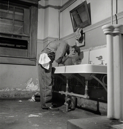 Photo showing: Work, Read, Wash -- March 1943. Barstow, California. Railroad worker in the washroom of the reading room in the Santa Fe yard.