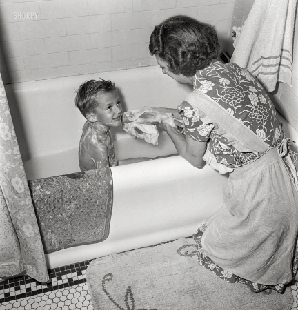 Photo showing: Tub Time -- September 1942. Rochester, New York. Earl Babcock's mother helping with his bath.