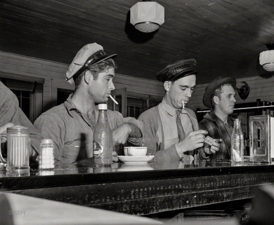 Photo showing: Mac, Bud and Pal -- March 1943. Pearlington, Mississippi (vicinity). Truck drivers at a highway coffee stop on U.S. Highway 90.