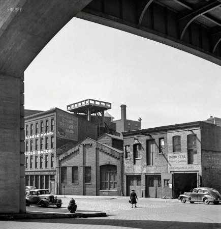 Photo showing: Reliable Hams -- April 1943. Baltimore, Maryland. Street under viaduct.