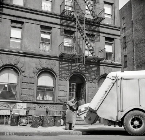 Photo showing: Garbage Out -- May 1943. New York. Emptying garbage and trash from Harlem apartment houses.