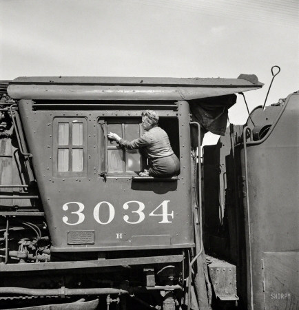 Photo showing: Window Seat. -- May 1943. Clinton, Iowa. Women wipers of the Chicago & North Western cleaning one of the giant freight locomotives.