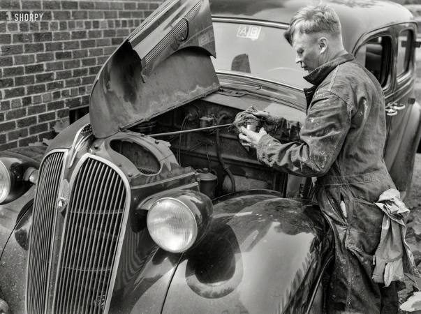Photo showing: Plymouth Service -- June 1943. Silver Spring, Maryland. Man repairing his automobile.