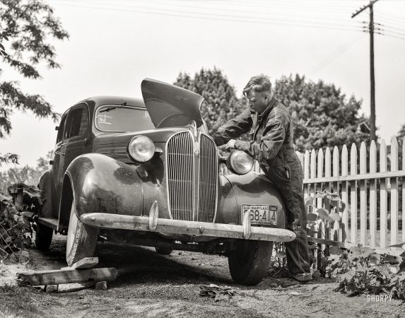 Photo showing: Backyard Mechanic -- June 1943. Silver Spring, Maryland. Man repairing his automobile.