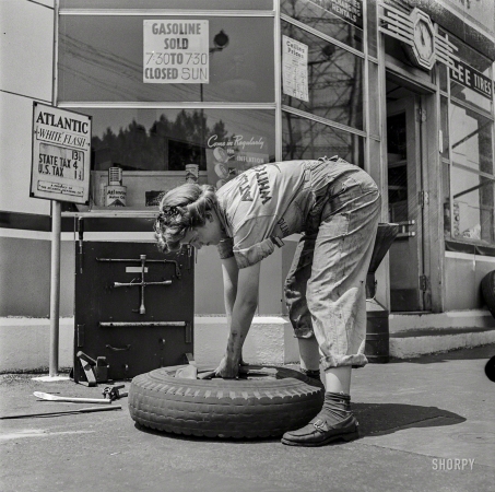 Photo showing: Tire Jockey -- June 1943. Miss Natalie O'Donald, service station attendant at an Atlantic Refining Company garage in Philadelphia.