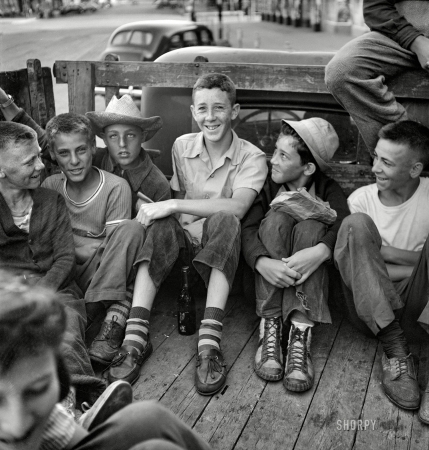 Photo showing: American Pickers. -- June 1943. Oswego, New York. Children, recruited for farm work,
waiting outside the U.S. Employment Service to start work for the summer.