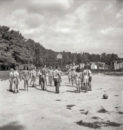 Photo showing: Dodgeball -- August 1943. Middle River, a small crossroads in the vicinity of Baltimore.Housing for
Glenn L. Martin aircraft workers. Play period for children attending Bible class.