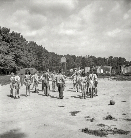 Photo showing: Dodgeball -- August 1943. Middle River, a small crossroads in the vicinity of Baltimore.Housing for
Glenn L. Martin aircraft workers. Play period for children attending Bible class.