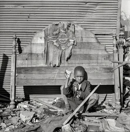 Photo showing: Toy Story -- July 1943. Washington, D.C. A child whose home is an alley dwelling near the U.S. Capitol.